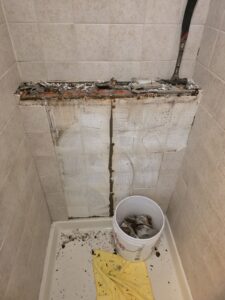 Broken shower tile before repair in Glenview, IL