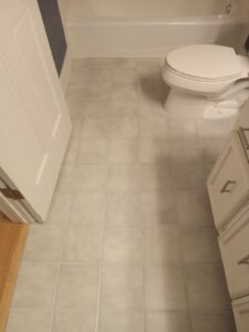 Bathroom floor after grout cleaning, repair and color sealing in Wheaton IL